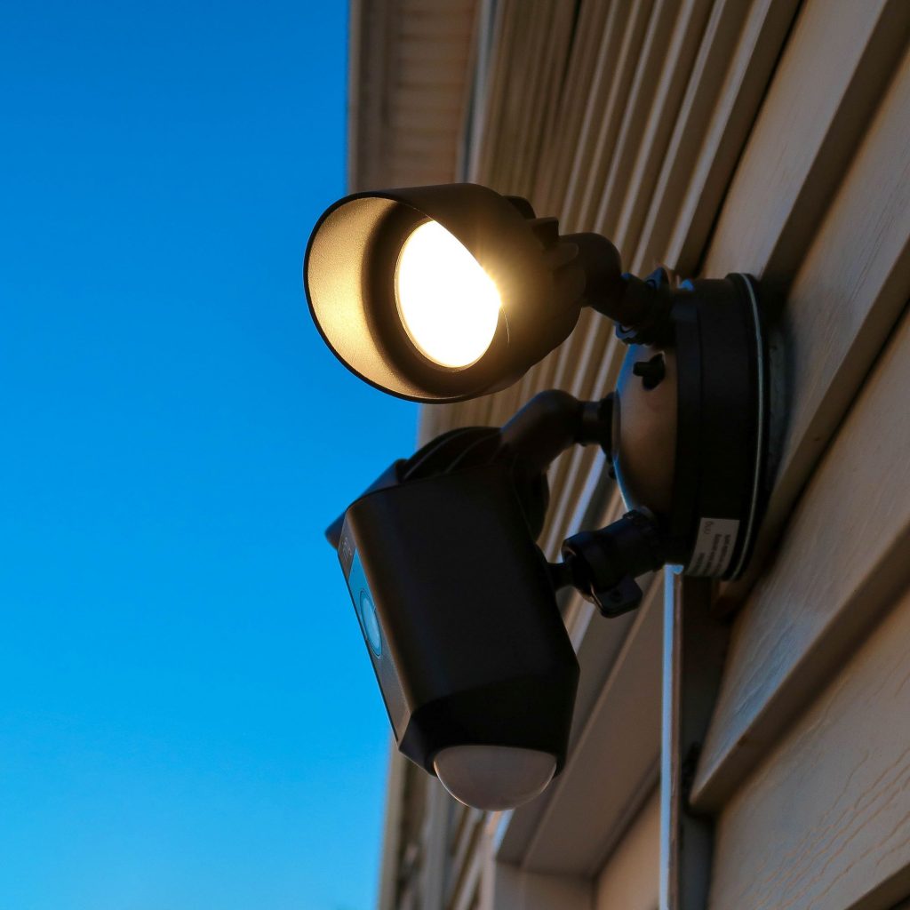 Smart security camera and floodlight installation on a home exterior